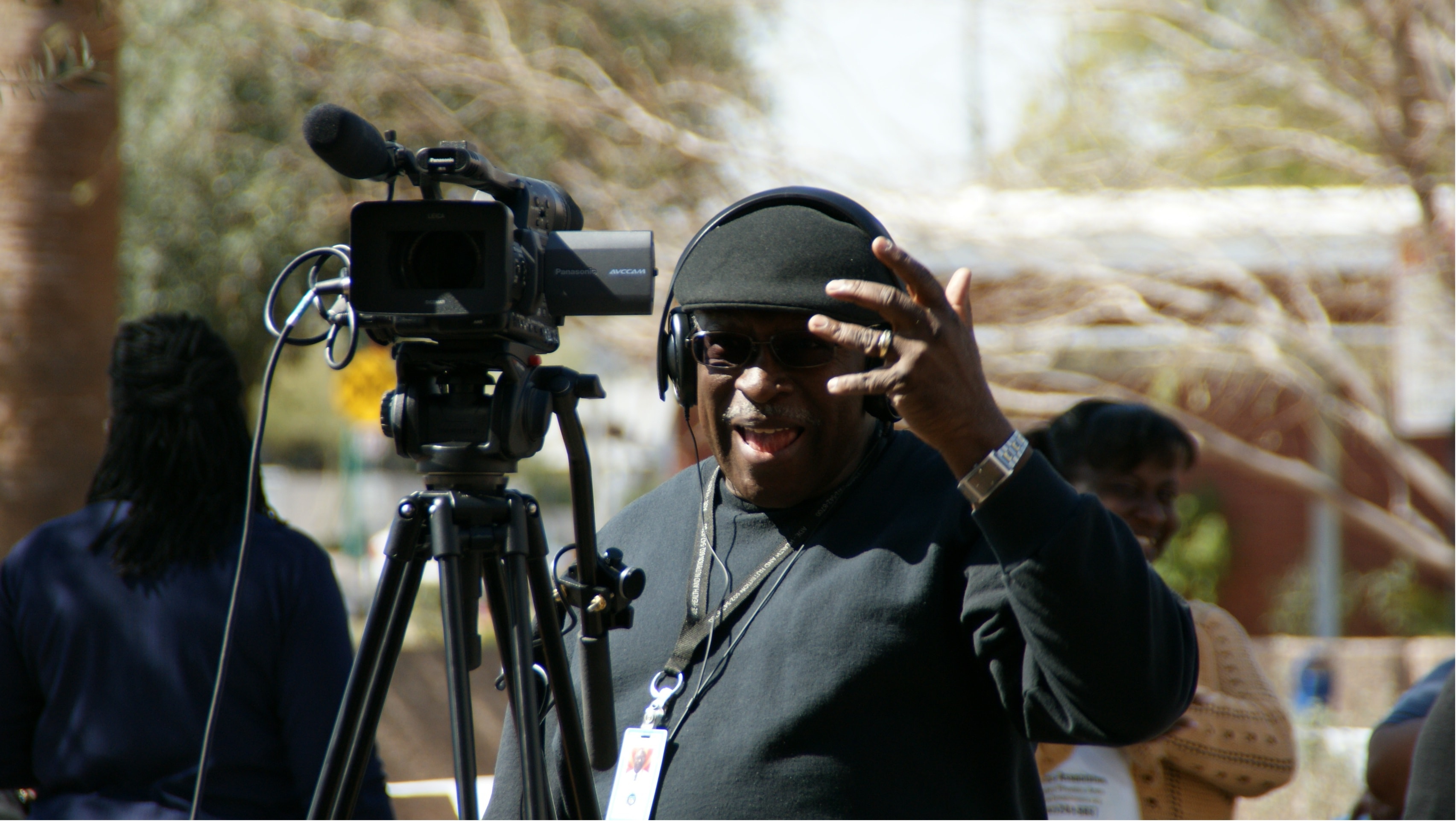 Dallas Teat directing on set with camera and headphones