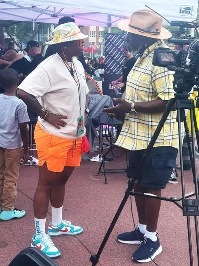 Director filming at an outdoor community event